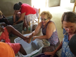Ani washing feet in Haiti
